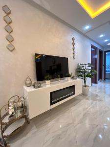 a living room with a tv on a wall at Mini Villa 2 Al hoceima in Al Hoceïma