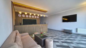 a living room with a couch and a flat screen tv at Panorama 7 day's in Hacıselli
