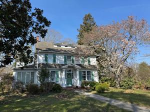 a white house with a green door at Camden at Monticello in Salisbury