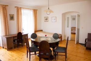 a living room with a table and chairs and a bed at Zámek Dobrohoř in Dobrohoř