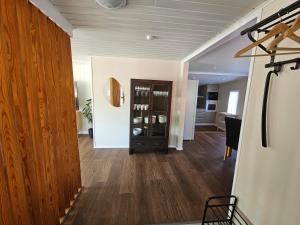 a living room with wood floors and a dining room at Sandmo Holiday Home 13 in Eckerö +9 photos