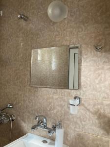 a bathroom with a sink and a mirror at Къща за гости Ягода in Sapareva Banya +17 photos