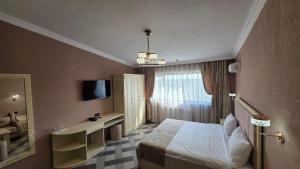 a hotel room with a bed and a mirror at Panorama 7 day's in Hacıselli