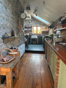 a kitchen with a counter and a stone wall at THE FARMHOUSE Room 1 in Balcunnin
