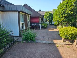 a brick walkway next to a house with a patio at Sandmo Holiday Home 13 in Eckerö