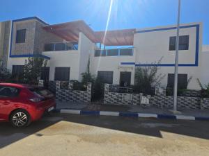 a red car parked in front of a house at Mini Villa 2 Al hoceima in Al Hoceïma +4 photos