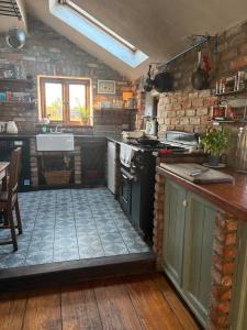 a kitchen with a stove and a sink at THE FARMHOUSE Room 1 in Balcunnin +19 photos