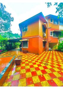 a building with a checkered floor in front of it at Serene Guest House ll 2 Ac Rooms ll WiFi ll Tv ll Big Garden in Lonavala