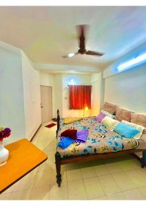 a bedroom with a bed and a ceiling fan at Serene Guest House ll 2 Ac Rooms ll WiFi ll Tv ll Big Garden in Lonavala
