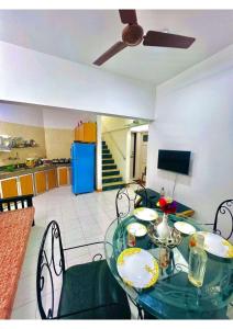 a dining room with a glass table and chairs at Serene Guest House ll 2 Ac Rooms ll WiFi ll Tv ll Big Garden in Lonavala
