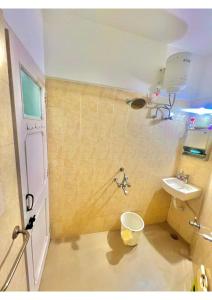 a bathroom with a toilet and a sink at Serene Guest House ll 2 Ac Rooms ll WiFi ll Tv ll Big Garden in Lonavala +21 photos