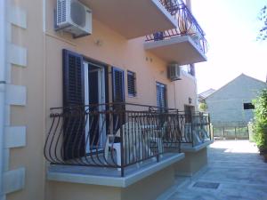 a balcony of a building with chairs on it at room&4you in Supetar +10 photos