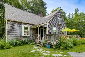 a small house with a porch with a deck at Deck & Fire Pit: Cottage Near Monadnock State Park in Jaffrey