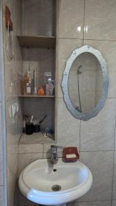 a bathroom with a sink and a mirror at Guest house in Ipnari