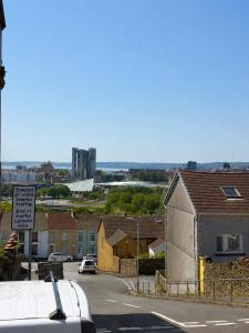 a view of a street with houses and a sign at 52 - room 4 - city view in Swansea