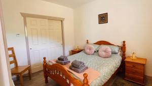 a bedroom with a bed with towels on it at Bathach Mor in Oban