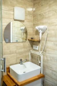 a bathroom with a white sink and a mirror at Domki Pod Lasem Lubkowo in Lubkowo +76 photos