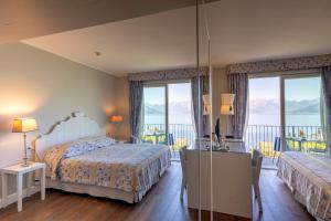 a hotel room with two beds and a balcony at Borgo Le Terrazze in Bellagio +208 photos