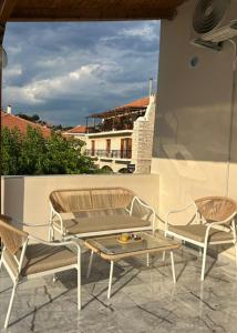 two chairs and a table on a patio at Arco Boutique Apartments in Paralio Astros