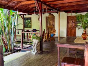 a room with a table and some plants in it at Hotel Boutique Casa Mambo in Cahuita