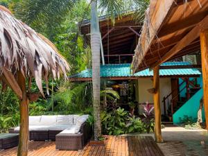 a house with a white couch on a patio at Hotel Boutique Casa Mambo in Cahuita