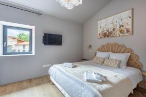 a bedroom with a large bed and a window at Gite De La Borie in Saint-Ignat