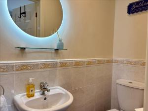 a bathroom with a sink and a mirror at Seagulls Rest - Sheringham in Sheringham +8 photos