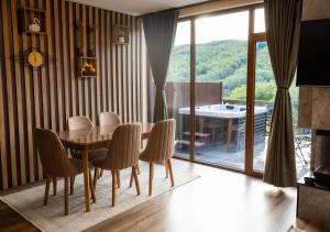 a dining room with a table and chairs at Villa Loni in Pozharan