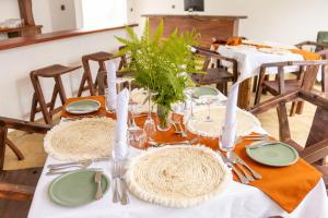 a table with plates and utensils on top at Olarashii River Lodge in Arusha