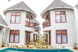 an apartment building with a pool in front of it at Olarashii River Lodge in Arusha