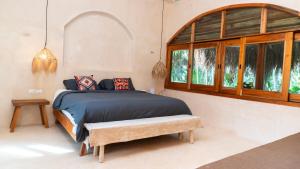 a bedroom with a bed and a large window at Villa Hydra Private Villa with Rooftop Pool in El Cuyo +18 photos