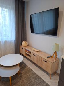 a living room with a tv on the wall at Atokvėpis sielai in Šilutė