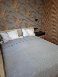 a bed with two pillows in a bedroom at Atokvėpis sielai in Šilutė