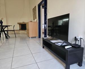 a living room with a large flat screen tv at Seven Plus in Filiatra