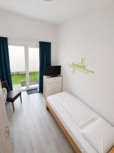 a bedroom with a bed and a tv in it at Apartment Hofacker in Pernegg an der Mur