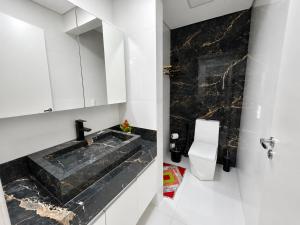 a bathroom with a sink and a toilet at Aconchego de Lugar - Eri & Douglas - 4 in Belo Horizonte +8 photos