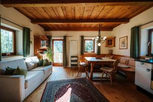 a living room with a couch and a table at Kellerstöckl Kranach 76 in Gamlitz