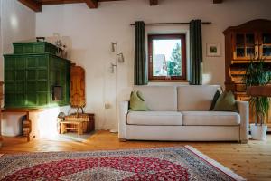a living room with a couch and a window at Kellerstöckl Kranach 76 in Gamlitz