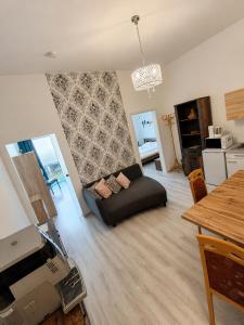 a living room with a couch and a table at Apartment Hofacker in Pernegg an der Mur