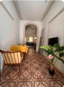 a hallway with a table and a chair in a room at Maltese House Gzira Central in Il-Gżira