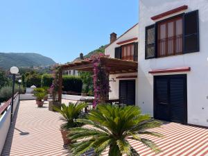 a balcony of a house with plants and flowers at Villa Aurora in Vico Equense