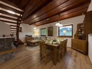 a dining room and living room with a table and chairs at Chata na Lániku in Švošov