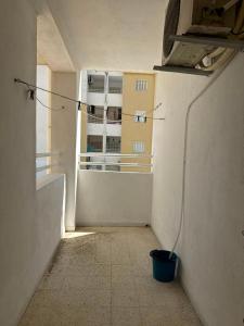 an empty room with a view of a building at Appartement près de la corniche in Sousse
