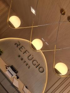 a sign for a hotel hanging from a ceiling at Hotel Refugio in Bonito +32 photos
