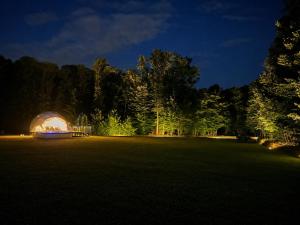 a marquee in a field at night at Kupolica glamping dome in Brčko