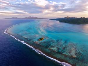 an aerial view of an island in the ocean at EDEN Private Island TAHAA in Patio
