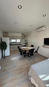 a room with a table and chairs and a kitchen at Base de los Andes 4 in Maipú