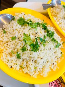 a yellow plate of rice with parsley on it at Siyara Hotel in Khamaria