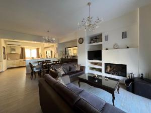 a living room with a couch and a dining room at Psichro Apartments Hera in Magoulás