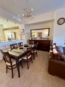 a dining room with a table and a couch at Psichro Apartments Hera in Magoulás +3 photos